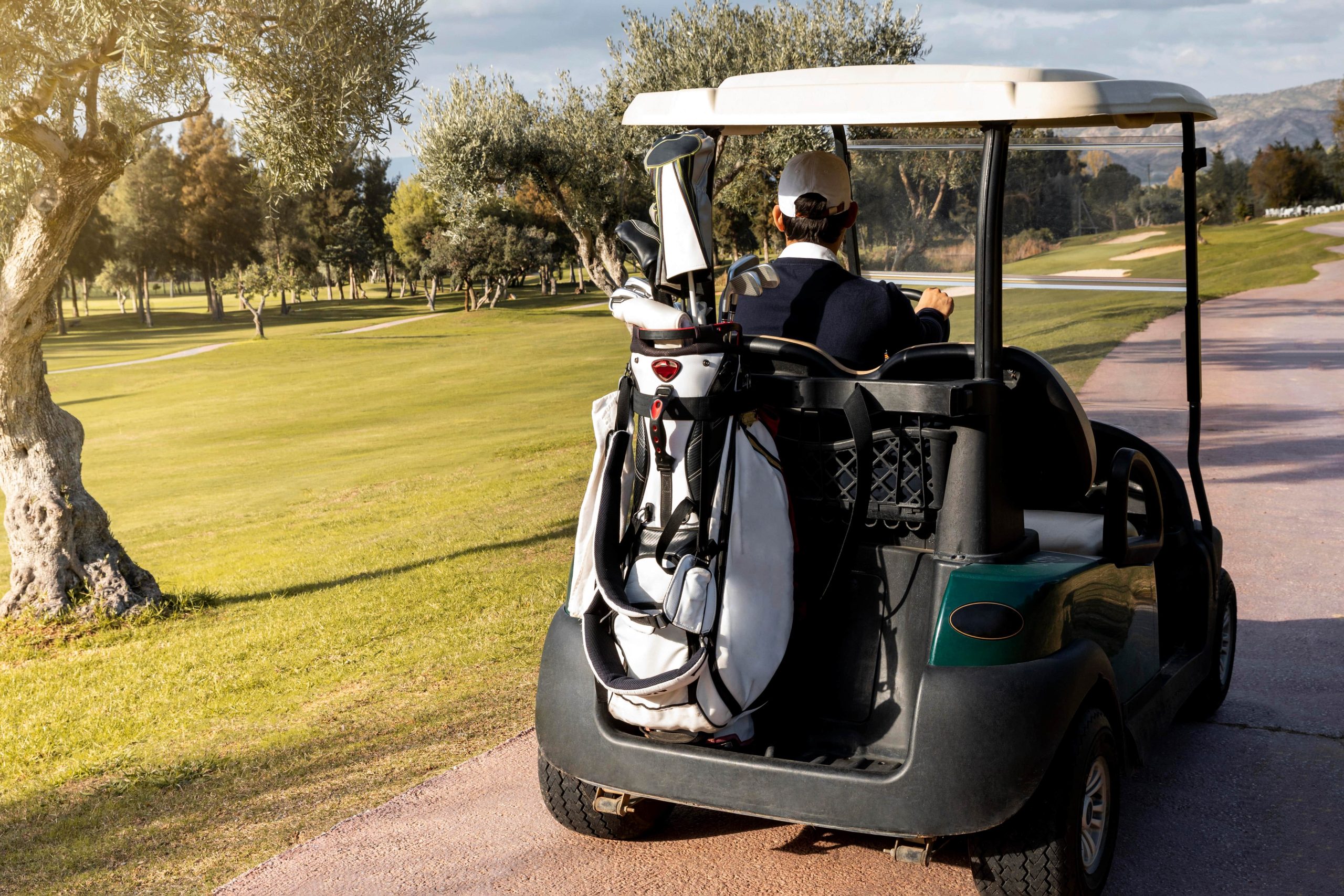 man with golf cart carrying clubs (1)